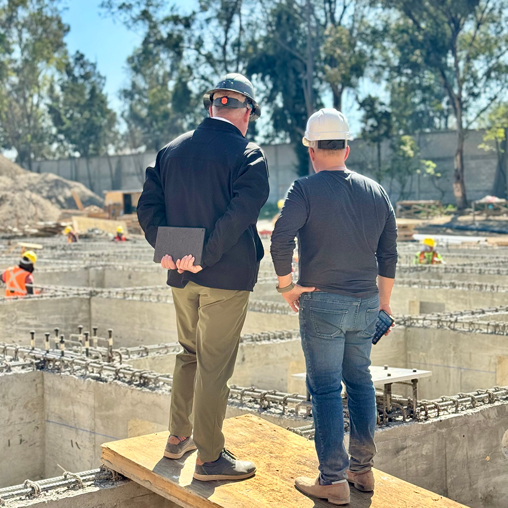 Volunteers and sisters reviewing building plans